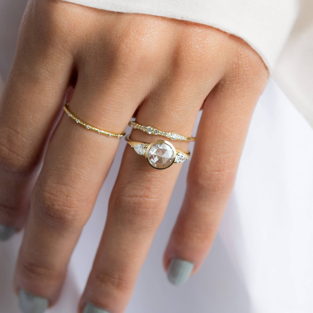 A Melanie Casey model wearing an Ascent Ring in Rose Cut paired with a Reverb Ring.