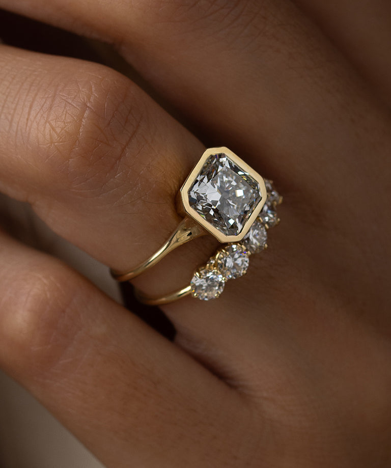 Photo features the Avenue Engagement Ring in Radiant Cut on a model's hand.