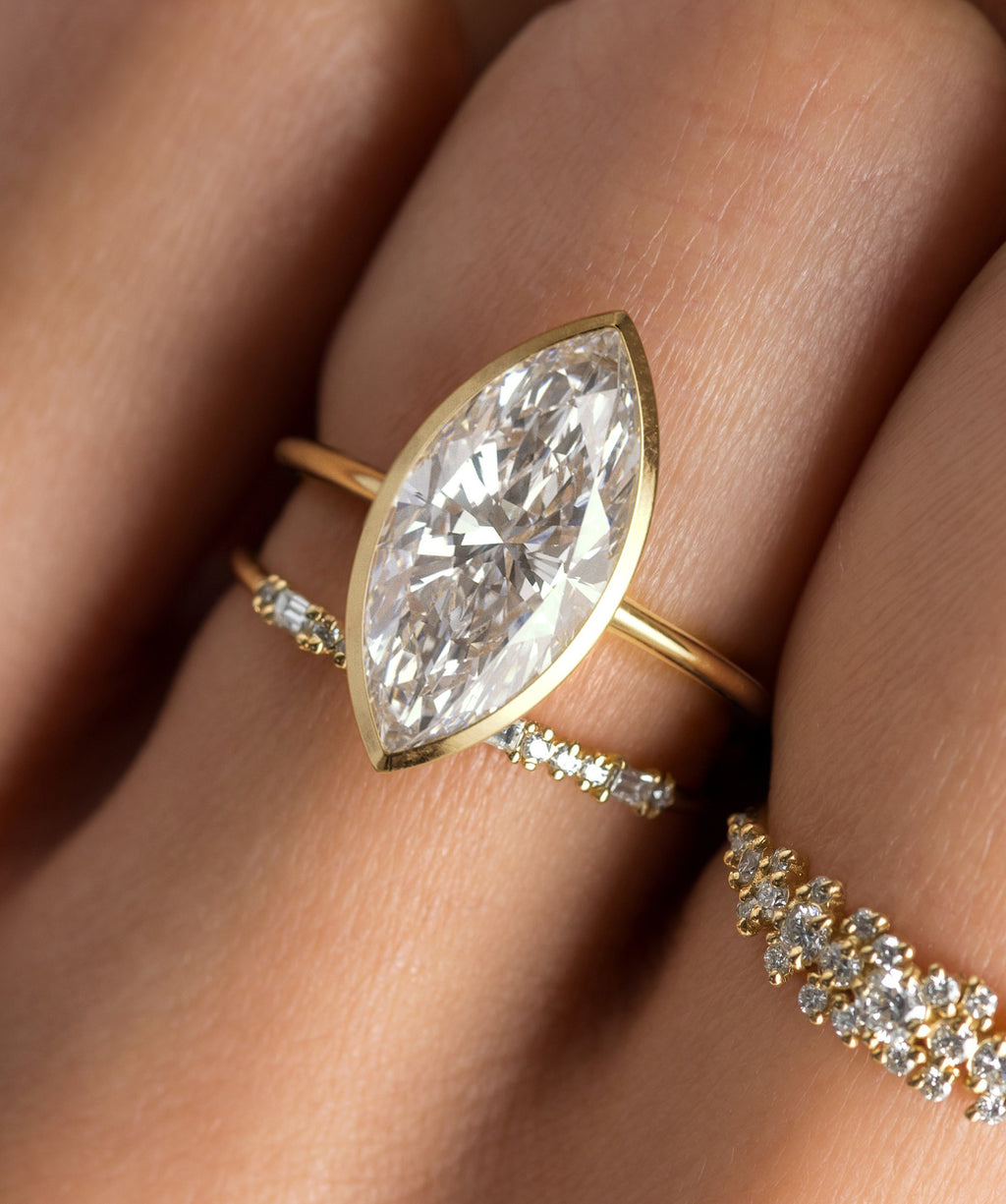 Photo features the Formation Bezel Engagement Ring in Marquise Cut on a model's hand.
