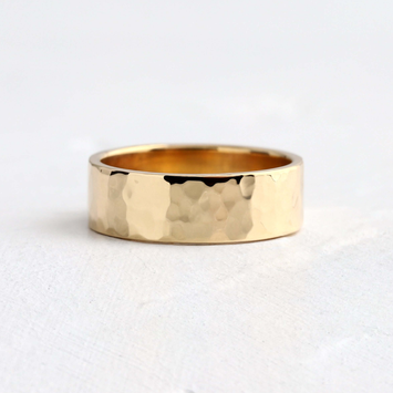 Photo shows a Melanie Casey Men's Hammered Band sitting on a textured white background.