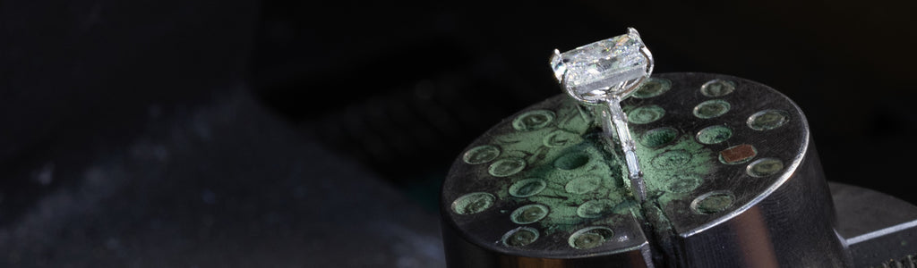 A radiant cut engagement ring in progress at the bench for the heirloom reset program.