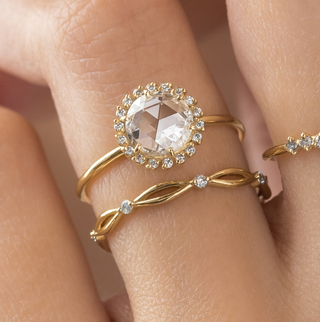 Photo showcases a model wearing the Luminary Rose Cut Ring paired with the Collide Band on her hand.