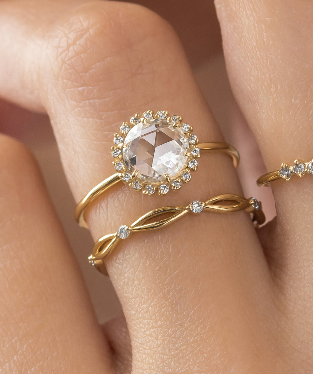 Photo showcases a model wearing the Luminary Rose Cut Ring paired with the Collide Band on her hand.