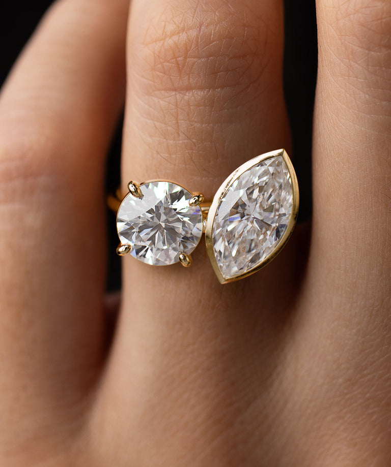 Photo features the Magnolia Engagement Ring in Round and Marquise Cuts on a model's hand.
