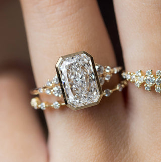 The Melanie Casey Snowdrift Ring Bezel Set in Radiant Cut being worn by a model.