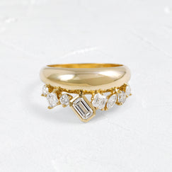 The Melanie Casey Cadance Band in 14k Yellow Gold shown from a front view sitting on a textured white background.