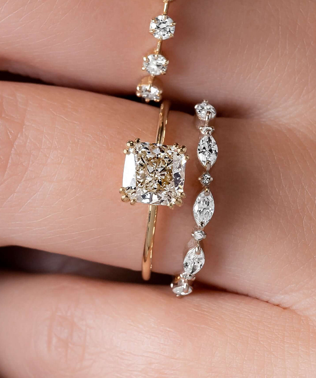 Model wearing the Melanie Casey Threaded Ring with a Cushion Cut center stone.