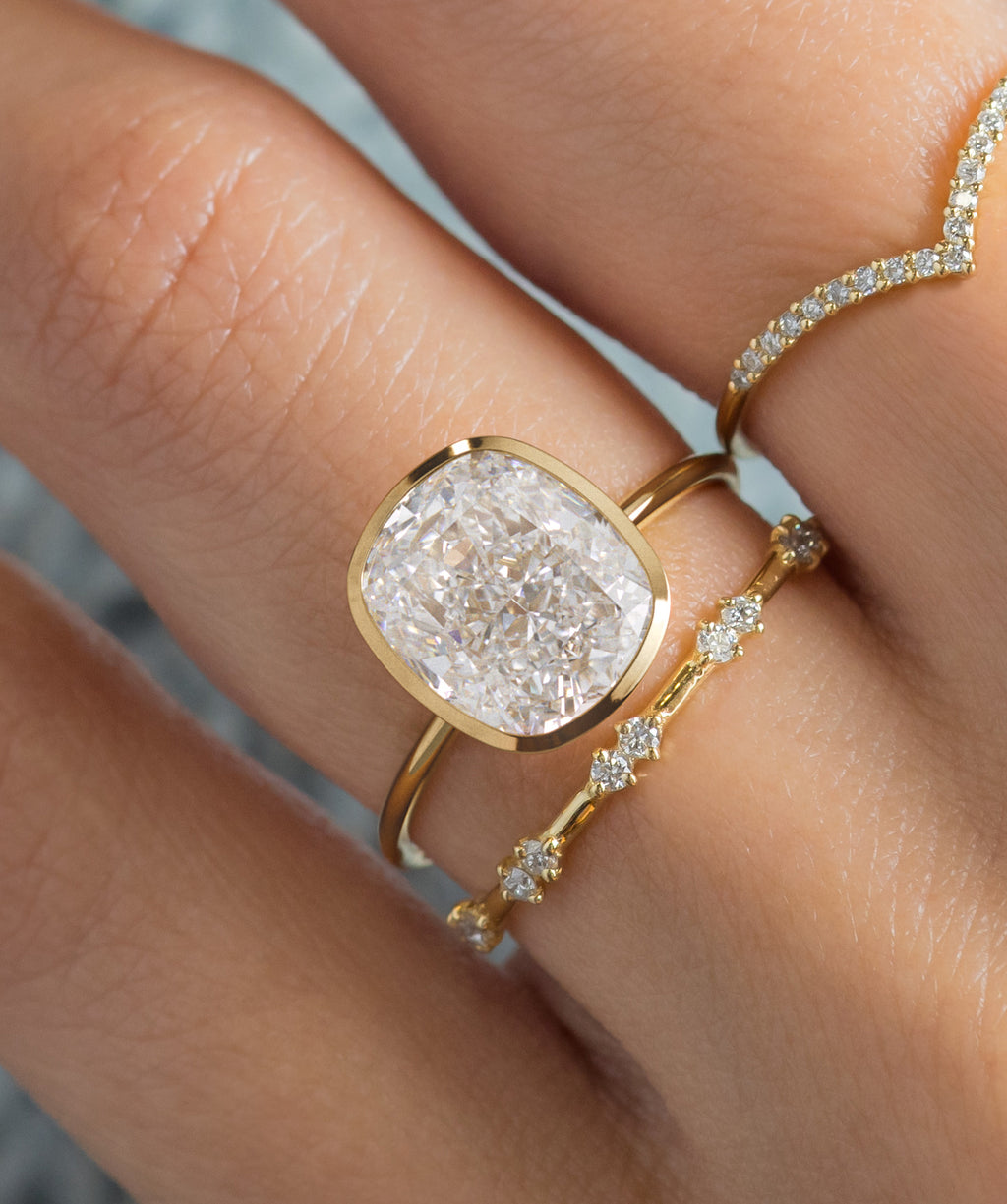 Model wearing the Melanie Casey Formation Ring in Cushion Cut.