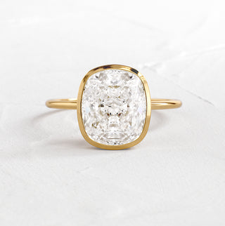 The Melanie Casey Formation Ring in 14k Yellow Gold sitting on a textured white background.