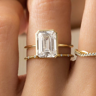The Melanie Casey Bezel Set Formation Ring in Emerald Cut being worn by a model.