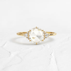 Ladys Slipper Rose Cut Engagement Ring in Yellow Gold by Melanie Casey shown on a textured white background