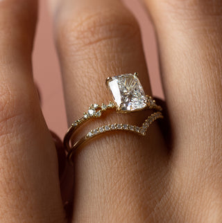 Photo showcases a model wearing the Melanie Casey Myriad Ring with an elongated cushion cut.