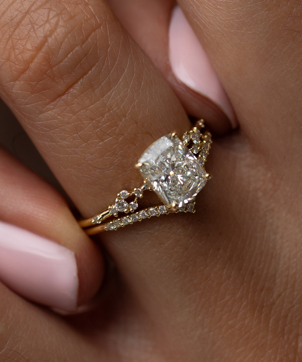 Model wearing the Melanie Casey Myriad Ring with a Cushion Cut center stone.