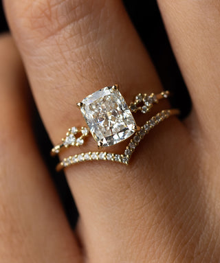 Photo showcases a model wearing the Melanie Casey Myriad Ring with an elongated cushion cut.