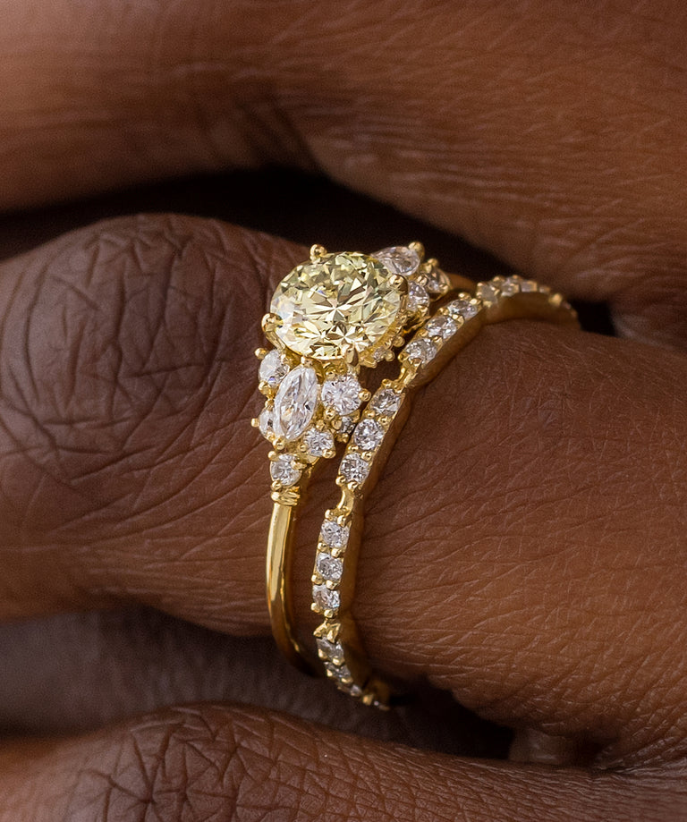 Photo showcases a model wearing the Nebula Ring with a yellow diamond center stone.