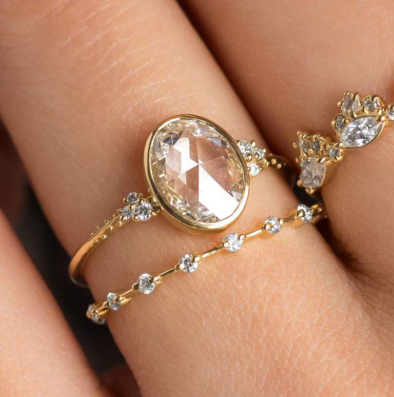 The Melanie Casey Bezel Set Pensive Ring in Oval Cut being worn by a model