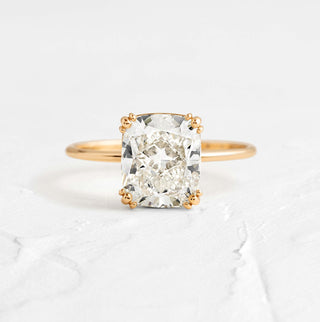 The Melanie Casey Threaded Ring in 14k Yellow Gold sitting on a textured white background.