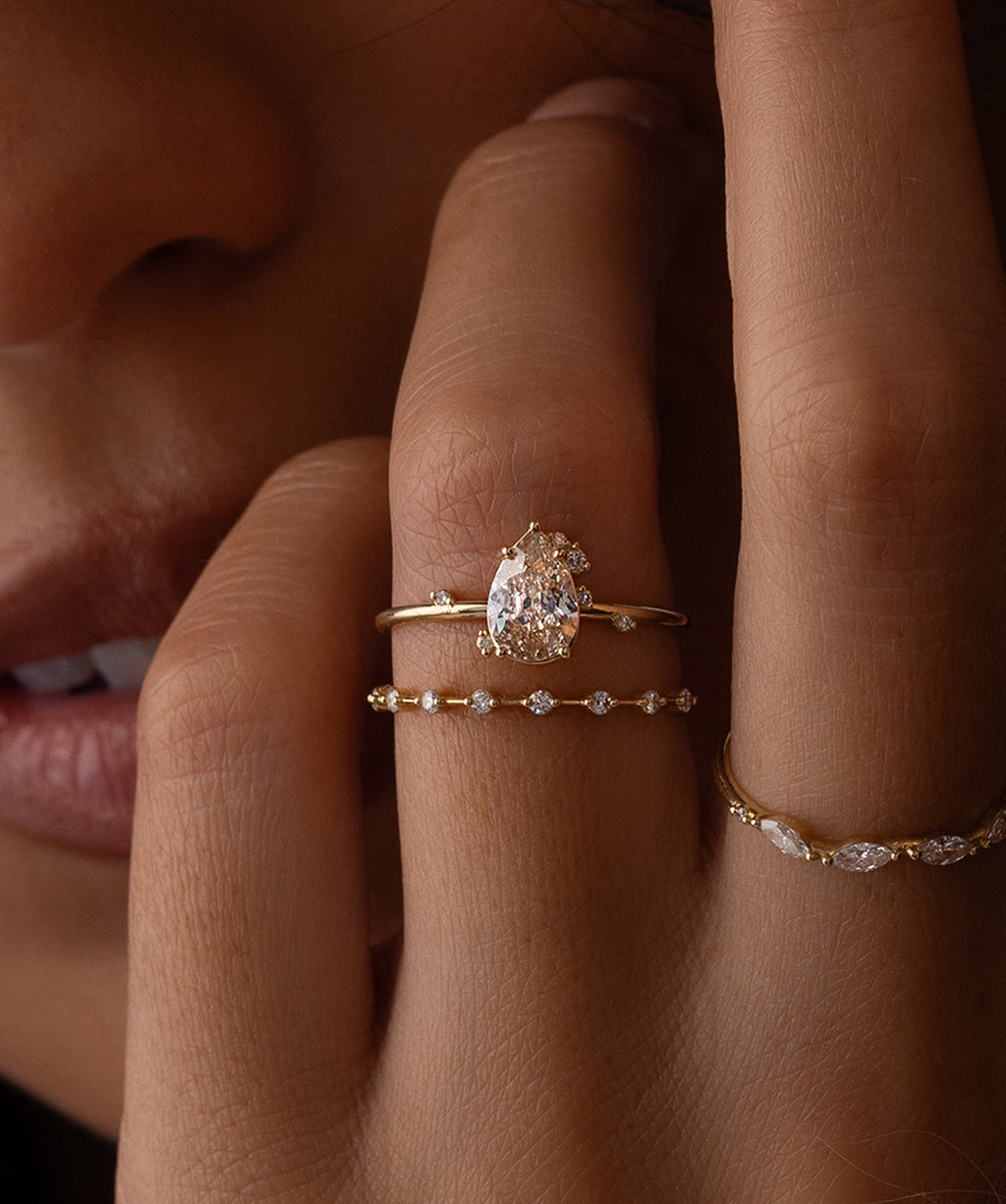 Photo features a model wearing the Melanie Casey To A Flame Ring with a 0.81ct. Natural Champagne Diamond center stone.