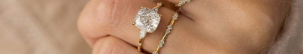 Model wearing the Melanie Casey Windlass Ring with a Cushion Cut center stone.