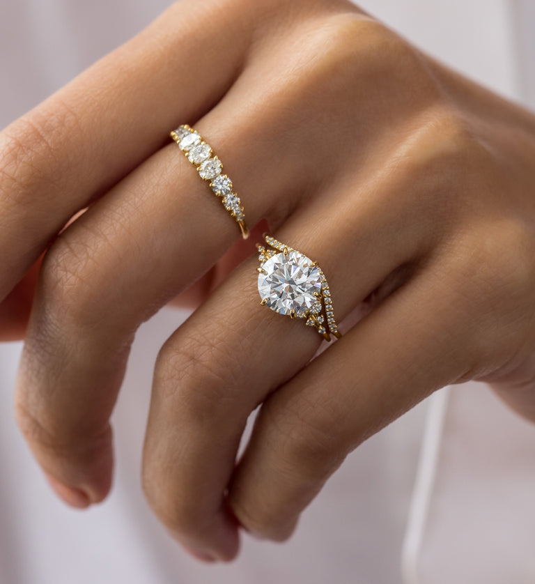 This photo showcases a model wearing the round cut Melanie Casey Snowdrift Ring.