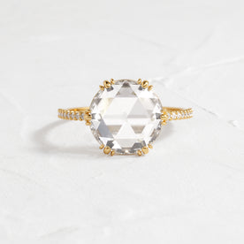 Moonlit Ring Rose Cut Engagement Ring in Yellow Gold by Melanie Casey shown on a textured white background