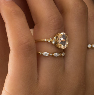 Photo showcases a model wearing the Snowdrift Ring in Rose Cut, shown from the side profile view.
