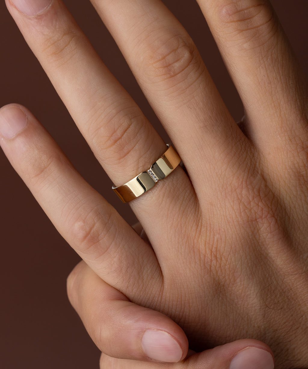 Photo showcases a model wearing the Melanie Casey Men's Channel Band on his hand.