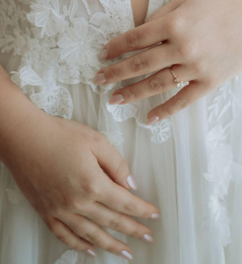 Nicole T in her wedding dress featuring her heirloom reset engagement ring.