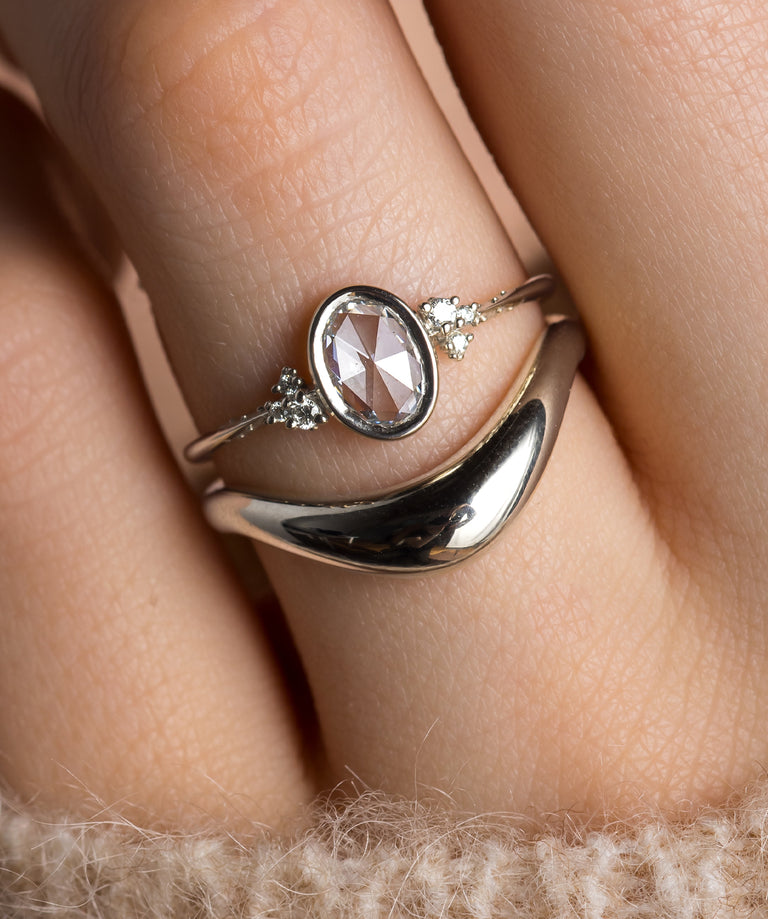 Photo showcases a model wearing the Pensive Bezel Set Rose Cut Ring paired with the Amplify Band on her hand.