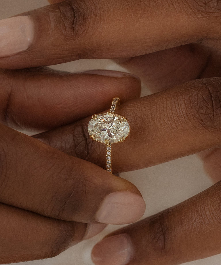 Melanie Casey model wearing the Starboard Ring in Oval Cut Diamond and Yellow Gold.