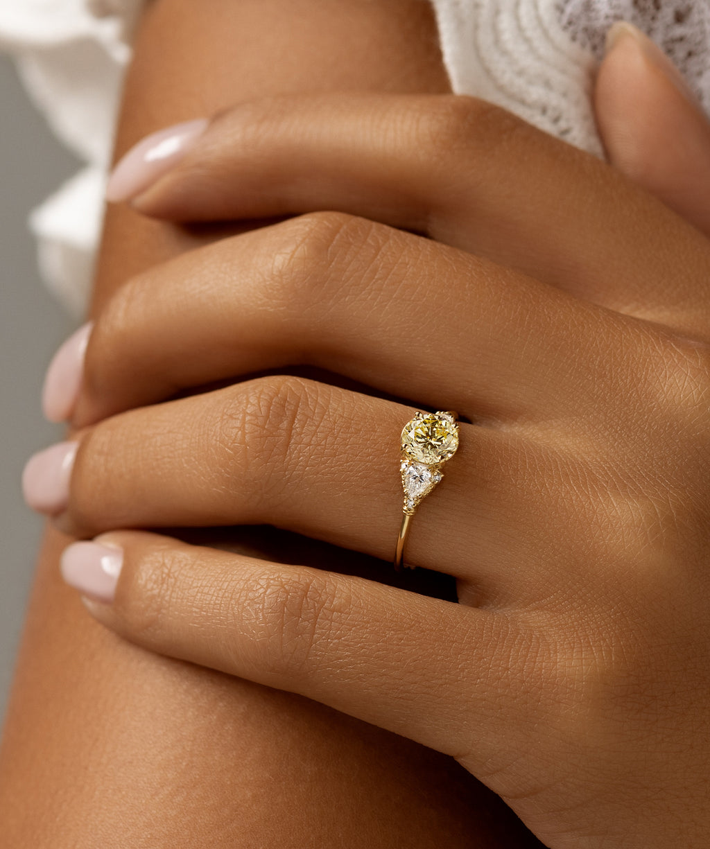 Photo features a model wearing the Melanie Casey Sunlit Ring featuring a yellow diamond center stone.