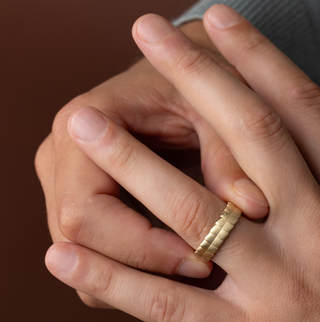 Photo showcases a model wearing the Melanie Casey Men's Terrain Ring on his hand.