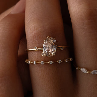 Photo features a model wearing the Melanie Casey To A Flame Ring with a 0.81ct. Natural Champagne Diamond as the center stone.