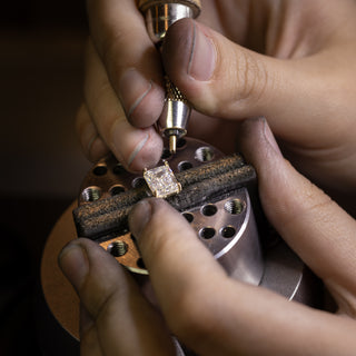 Bench jeweler working on a radiant cut solitaire engagement ring for the heirloom reset program.|Bench jeweler working on a radiant cut solitaire engagement ring for the heirloom reset program.