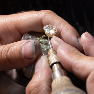 Bench jeweler working on a round cut solitaire engagement ring for the heirloom reset program.|Bench jeweler working on a round cut solitaire engagement ring for the heirloom reset program.