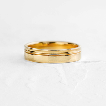 Photo shows a Melanie Casey Men's Double Sideline Band sitting on a textured white background.