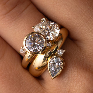 This photo showcase a model wearing the Motif Engagement Ring with a wide band.
