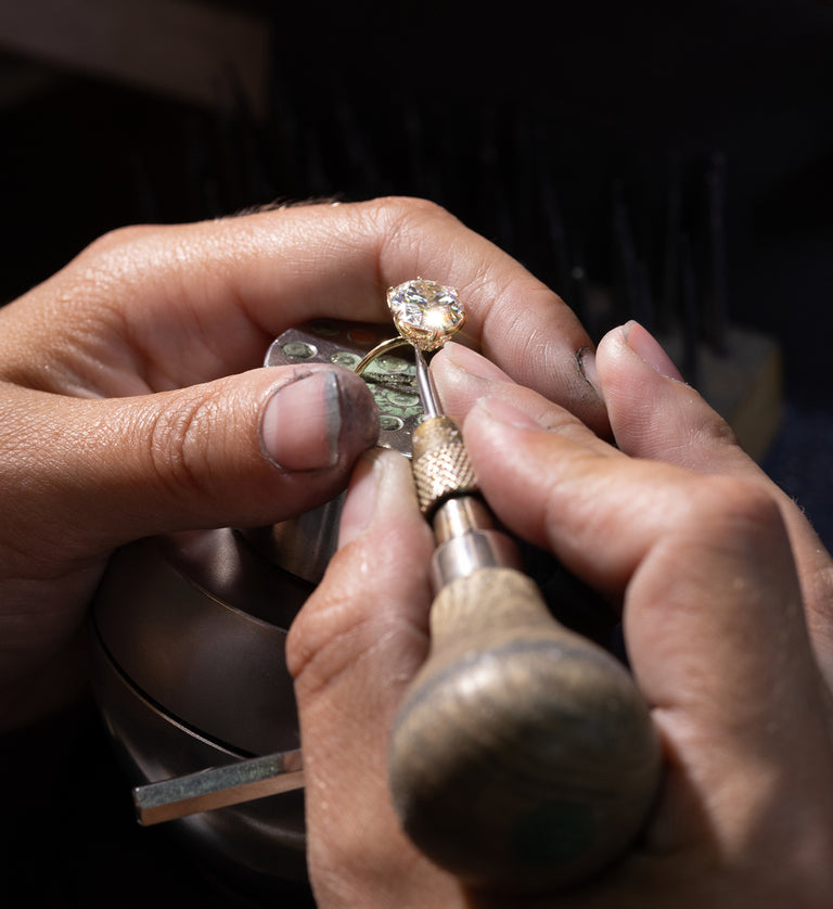 This feature showcased the hands of a Melanie Casey jeweler working with their hands on a round cut ring.