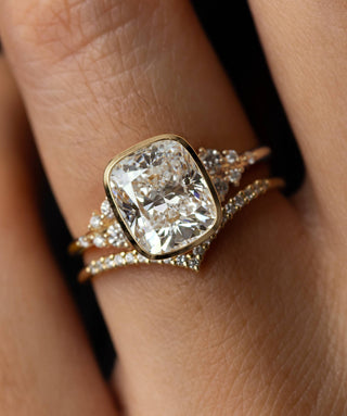 Model wearing the Melanie Casey Snowdrift Bezel Set Ring with a Cushion Cut center stone.