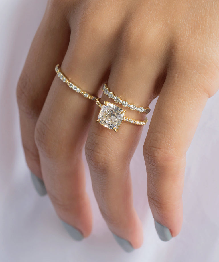 Model wearing the Melanie Casey Whisper Ring with a Cushion Cut center stone.