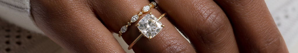 Model wearing the Melanie Casey Hemisphere Ring with a Cushion Cut center stone.