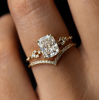 Photo showcases a model wearing the Melanie Casey Myriad Ring with an elongated cushion cut.