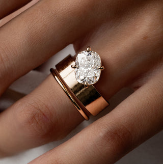 Photo showcases a model wearing the Melanie Casey Perplex Ring with a cushion cut.