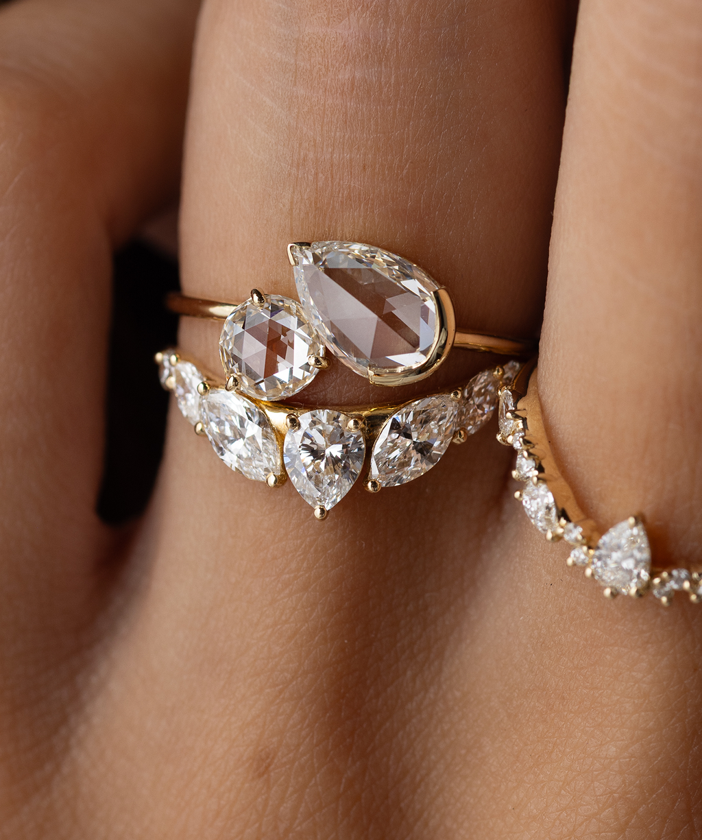 Photo features the one of a kind Melanie Casey Rose Cut Small Wonders Ring being held up by a model in a round ring box.