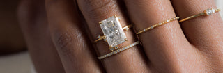 Photo showcases a model wearing the To a Flame Radiant Cut Ring.