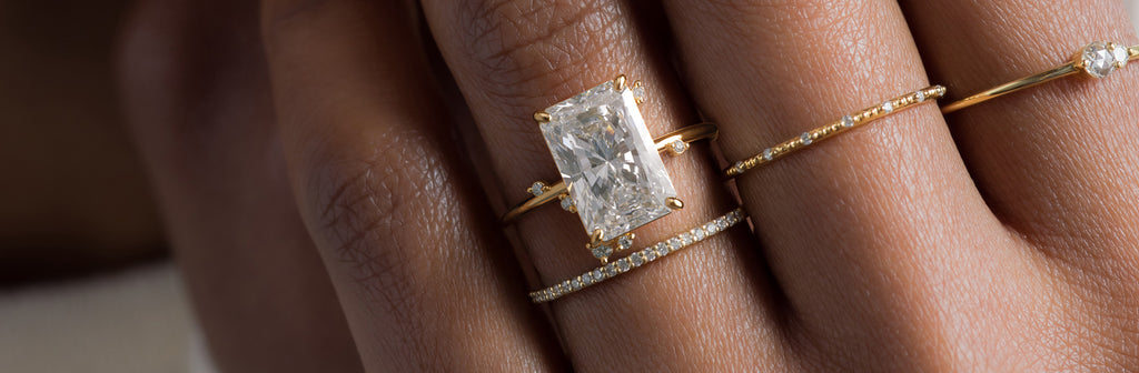 Photo showcases a model wearing the To a Flame Radiant Cut Ring.