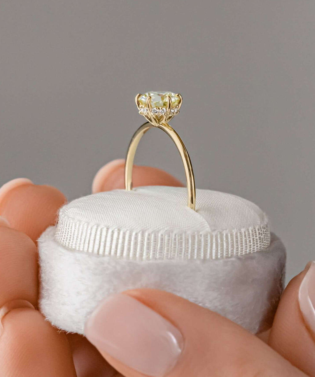 Photo features a model wearing the Melanie Casey  Touchpoints Ring with a yellow diamond center stone.