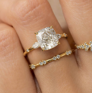 Model wearing the Melanie Casey Windlass Ring with a Cushion Cut center stone.