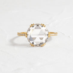 Moonlit Ring Rose Cut Engagement Ring in Yellow Gold by Melanie Casey shown on a textured white background