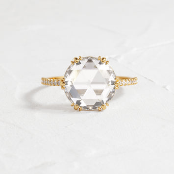 Moonlit Ring Rose Cut Engagement Ring in Yellow Gold by Melanie Casey shown on a textured white background